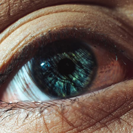 Detailed close-up of a human eye showcasing intricate iris patterns and texture.